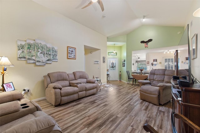 living room with ceiling fan, high vaulted ceiling, wood finished floors, and baseboards