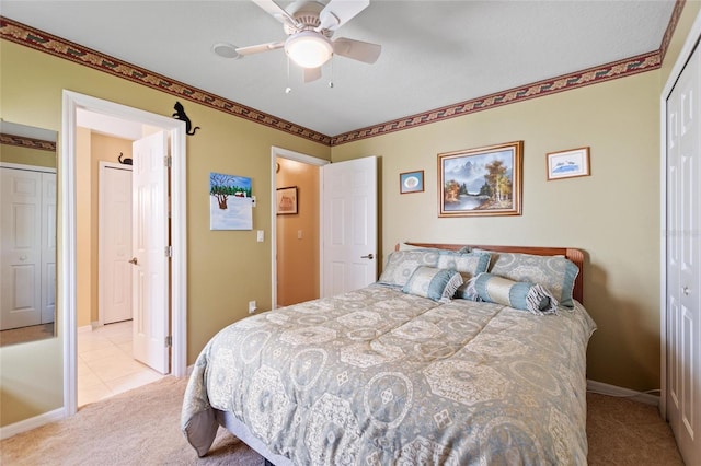 bedroom featuring light carpet, ceiling fan, and baseboards