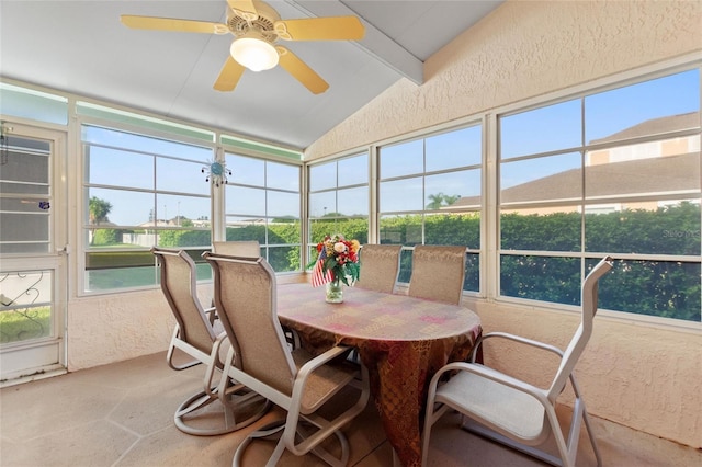 sunroom / solarium with vaulted ceiling and a ceiling fan