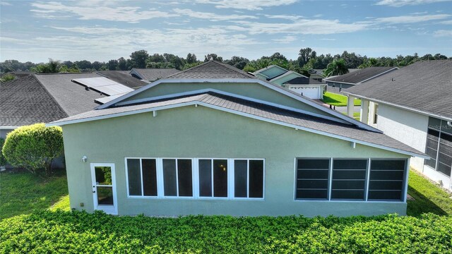 view of home's exterior featuring a shingled roof and stucco siding