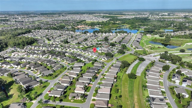 drone / aerial view with a water view and a residential view