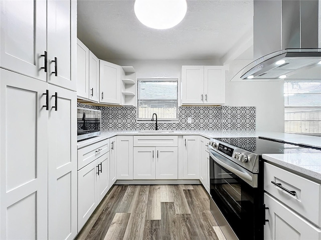 kitchen featuring island range hood, stainless steel appliances, a sink, white cabinets, and open shelves