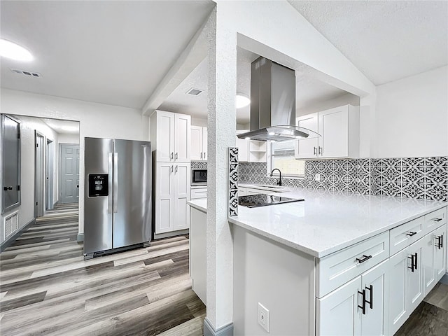 kitchen with stainless steel appliances, island exhaust hood, visible vents, and white cabinets