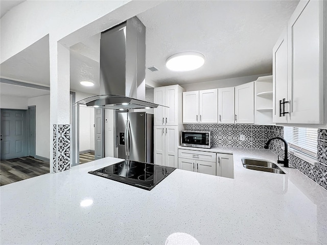 kitchen featuring island range hood, appliances with stainless steel finishes, white cabinetry, open shelves, and a sink