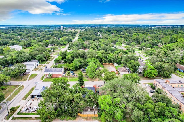 drone / aerial view with a residential view and a wooded view