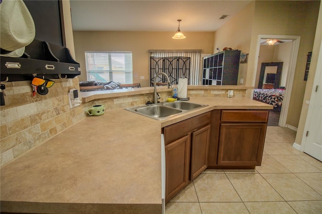 kitchen with hanging light fixtures, sink, and light tile patterned floors