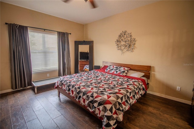 bedroom with dark hardwood / wood-style floors and ceiling fan