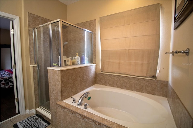 bathroom featuring tile patterned flooring and separate shower and tub