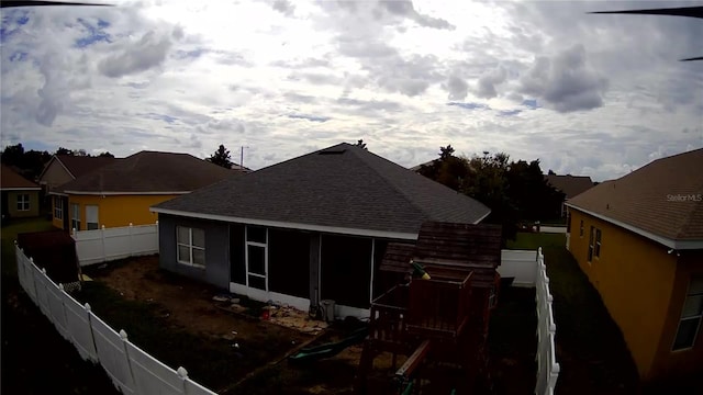 back of house featuring a sunroom