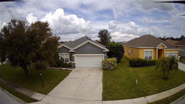 single story home featuring a garage and a front lawn