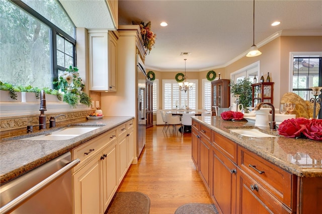 kitchen featuring dishwasher, ornamental molding, a sink, and light wood-style floors