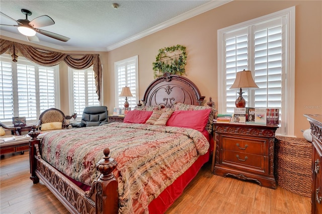 bedroom with a textured ceiling, wood finished floors, and crown molding