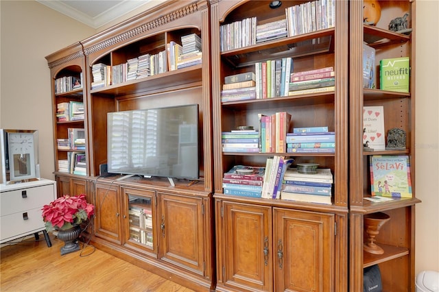 interior space with crown molding and wood finished floors