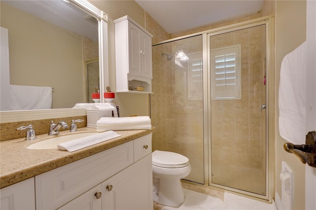 full bath featuring a stall shower, vanity, and toilet