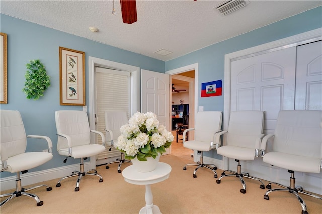 home office featuring baseboards, a textured ceiling, visible vents, and carpet flooring