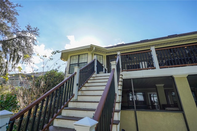 exterior space with stairs and stucco siding