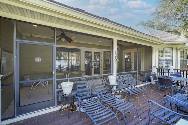 wooden deck with ceiling fan and french doors