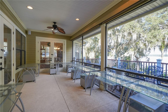 sunroom / solarium with ceiling fan and french doors