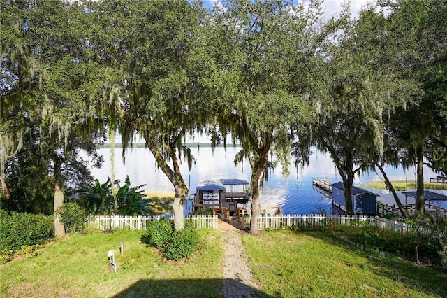 exterior space with a dock, fence, and a gazebo