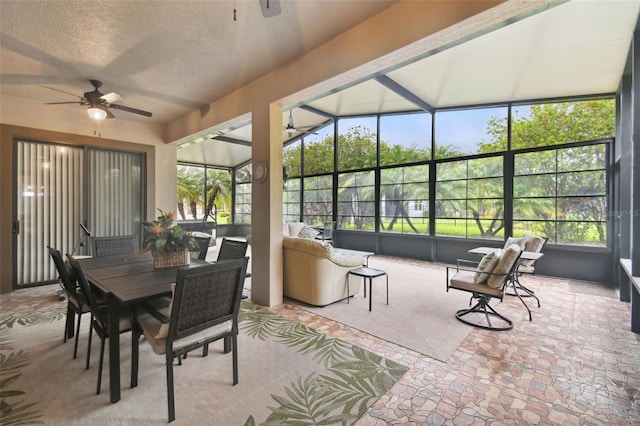 sunroom with ceiling fan and lofted ceiling