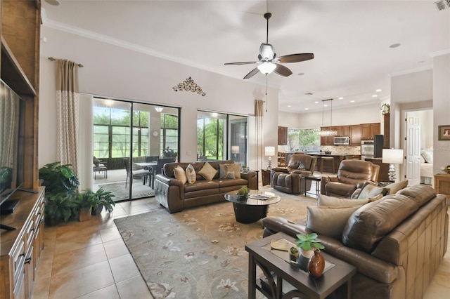 living room with ceiling fan, light tile patterned floors, and crown molding