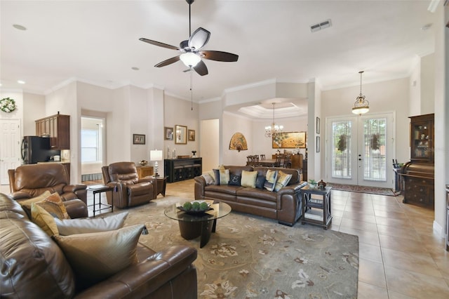 living room featuring ceiling fan with notable chandelier, light tile patterned floors, crown molding, and french doors