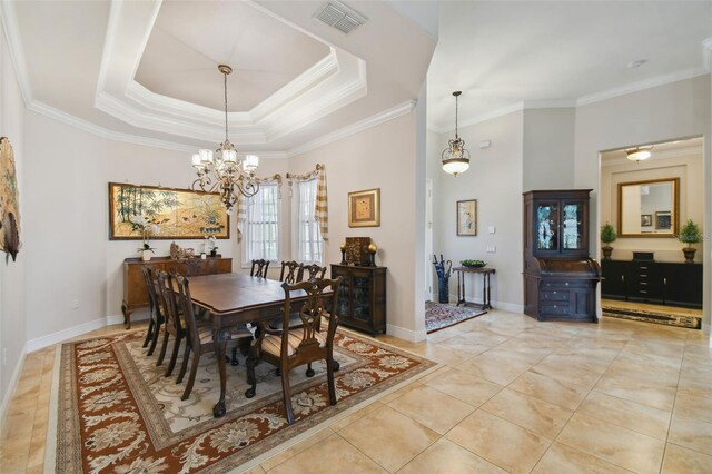 dining room with ornamental molding and a tray ceiling