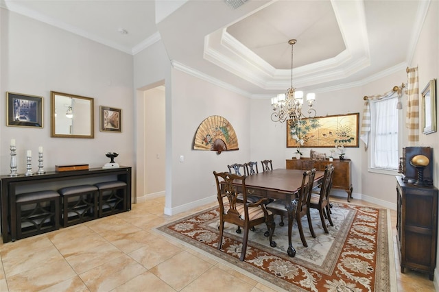 tiled dining space with a notable chandelier, ornamental molding, and a tray ceiling