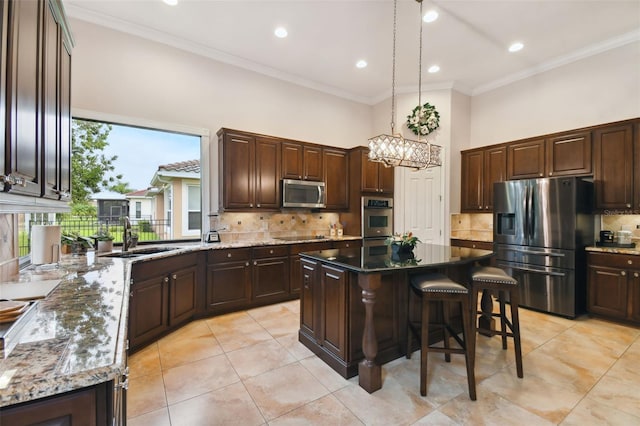 kitchen with appliances with stainless steel finishes, a center island, sink, and plenty of natural light