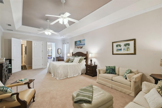 carpeted bedroom featuring ceiling fan, a raised ceiling, and crown molding