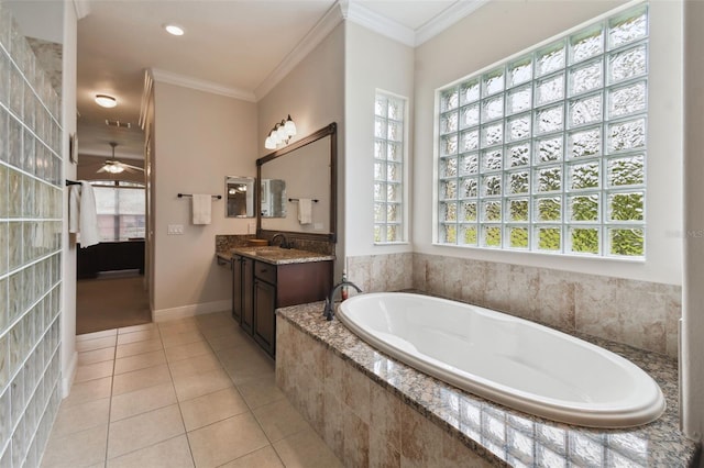 bathroom featuring tiled tub, ornamental molding, vanity, tile patterned floors, and ceiling fan