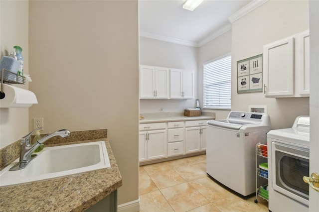 clothes washing area with washer and clothes dryer, cabinets, ornamental molding, light tile patterned floors, and sink