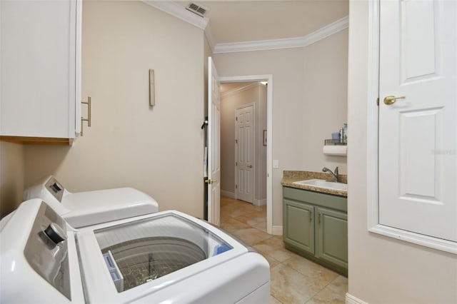 laundry room with cabinets, ornamental molding, independent washer and dryer, sink, and light tile patterned flooring