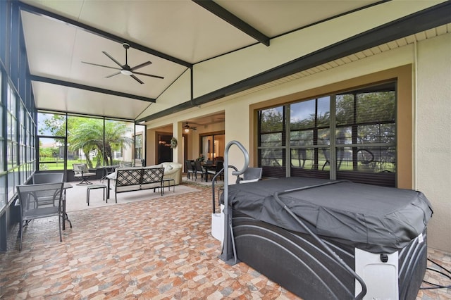 sunroom with ceiling fan and lofted ceiling with beams