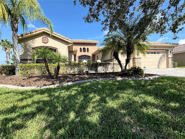 mediterranean / spanish-style house with a garage and a front yard