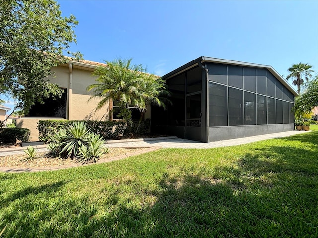 exterior space with a lawn and a sunroom