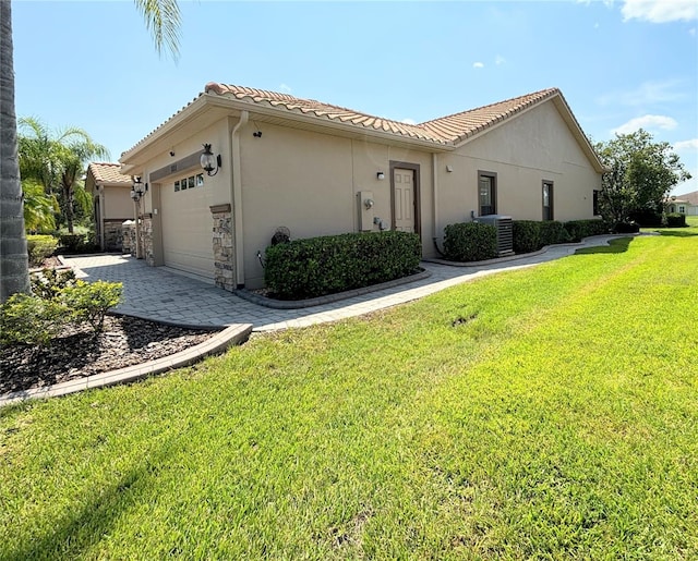 view of front of property with a front yard and a garage