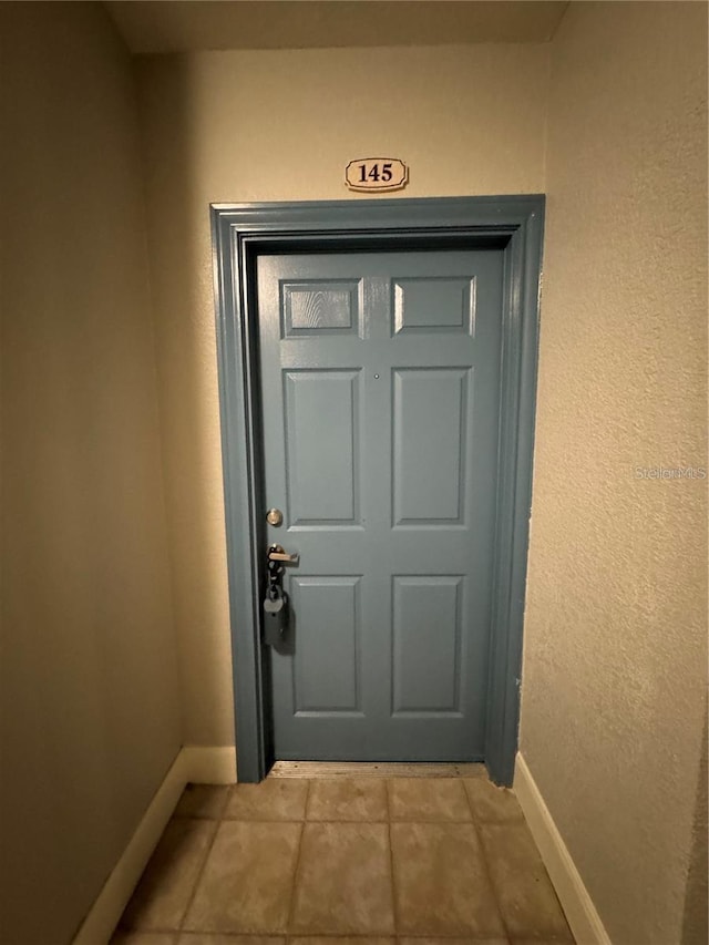 entryway with light tile patterned flooring