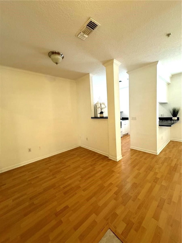 interior space with hardwood / wood-style flooring and a textured ceiling