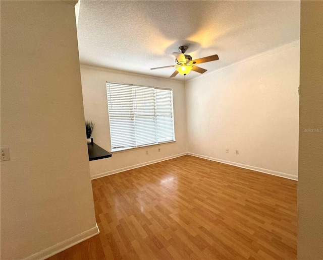 empty room with wood-type flooring, a textured ceiling, and ceiling fan