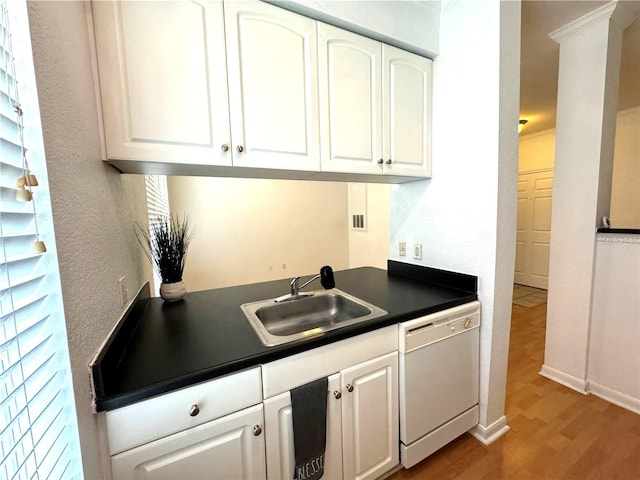 kitchen with white cabinets, white dishwasher, sink, wood-type flooring, and ornamental molding