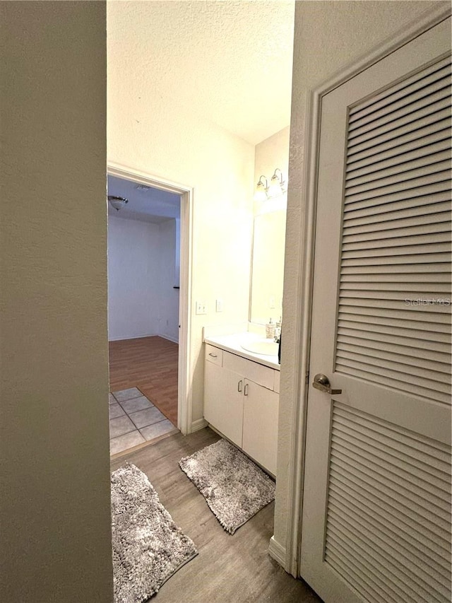 bathroom with vanity and hardwood / wood-style floors