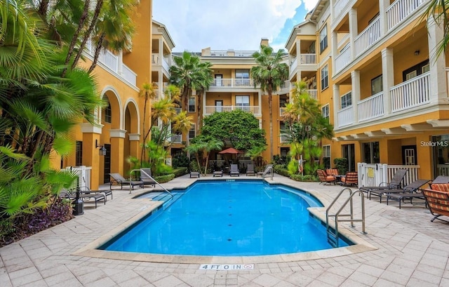 view of swimming pool featuring a patio area