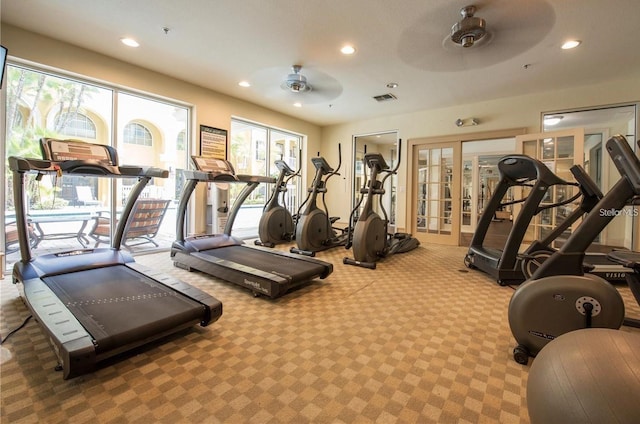 gym featuring french doors, ceiling fan, and carpet