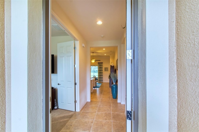 corridor with light tile patterned flooring