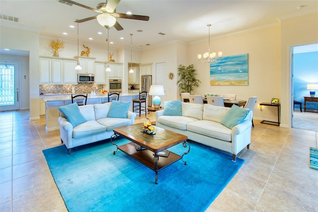 living room featuring light tile patterned floors, ornamental molding, and ceiling fan with notable chandelier