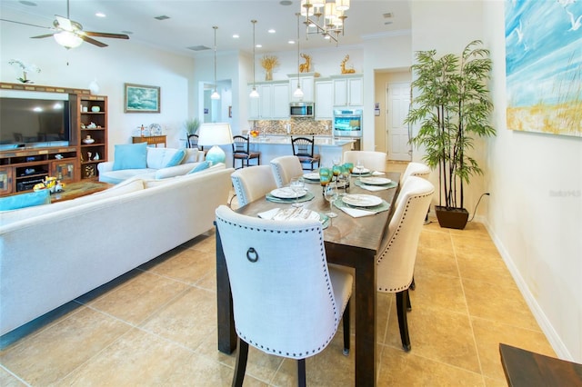 dining area with ceiling fan with notable chandelier, light tile patterned floors, and crown molding