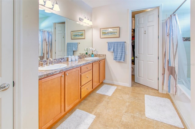 bathroom with vanity, shower / tub combo, and tile patterned floors