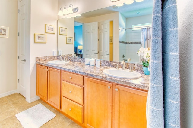 bathroom featuring tile patterned floors, a tile shower, and vanity