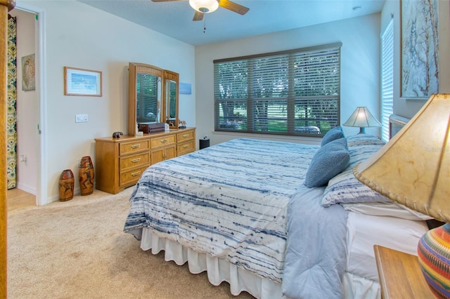 bedroom featuring ceiling fan and light carpet